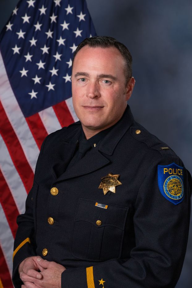 Photo of Lieuteant Brent Meyer in Class "A" uniform with the american flag in the background.