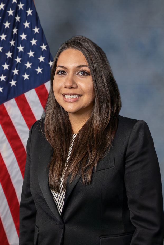 Photo of Nancy Molina with the american flag in the background 