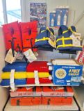 Image of variety of personal water flotation devices on a store shelf for sale