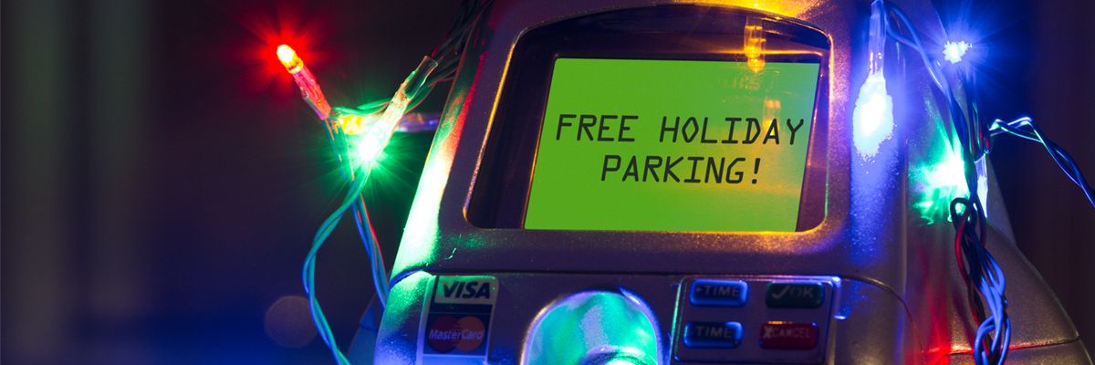 Image of parking meter reflecting the words, "Free Holiday Parking"