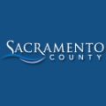 Image of blue Sacramento County agency log in white font and waves to simulate water