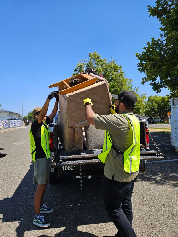 Neighbors loading chair into a truck