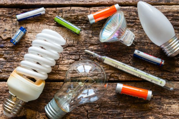 lightbulbs, batteries and shars on a table 