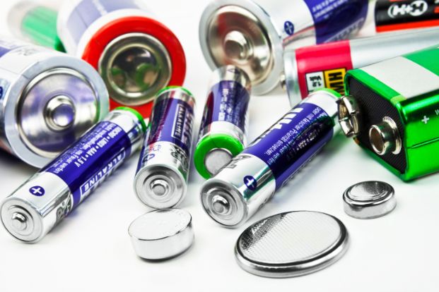 single-use disposal batteries spread out on a table. 