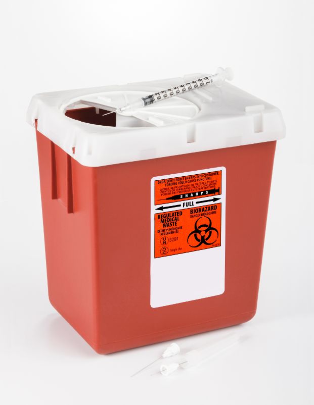 red plastic sharp container with syringe on top of the open container