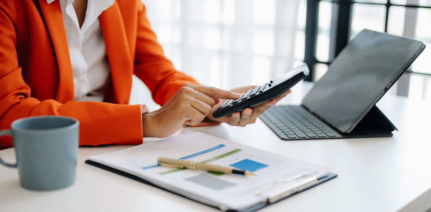 Business woman typing on calculator.