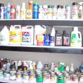 Shelf filled with cans of paint and bottles of cleaner