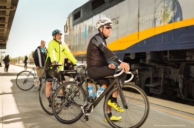Bike cyclists waiting to board train