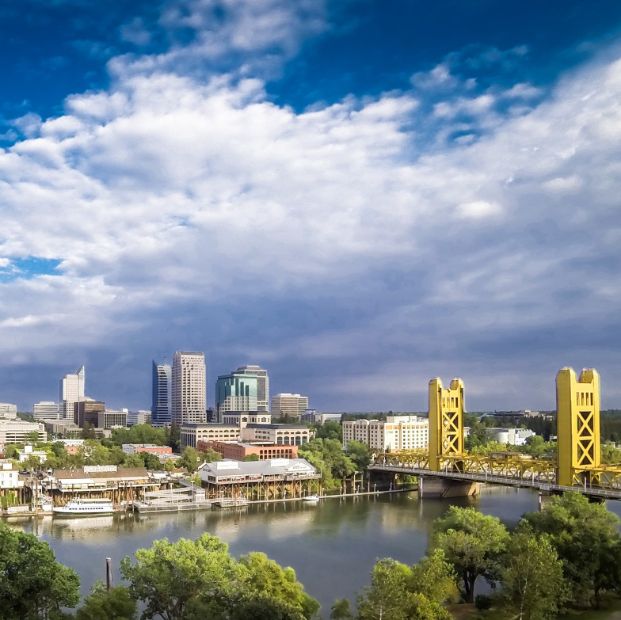 Photo of the Sacramento skyline with Tower Bridge and the Sacramento River in the foreground