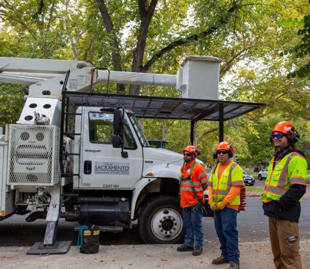 Maintenance workers standing in front of a City vehicle