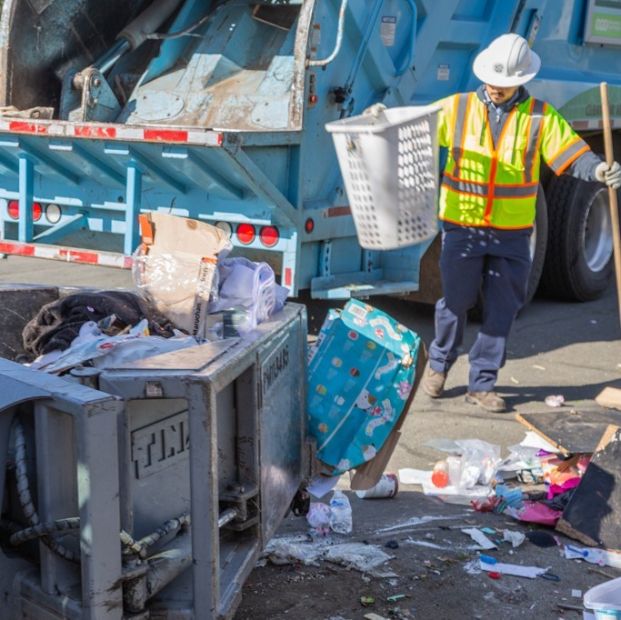 City maintenance worker picking up illegally dumped trash