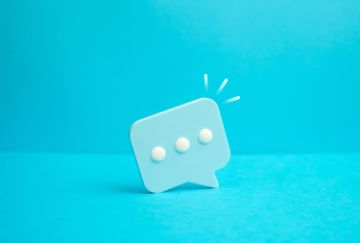 Blue animated graphic representing a verbal cartoon call-out with three white dots within