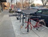 Image of a U-rack bicycle rack with a bike parked at it.