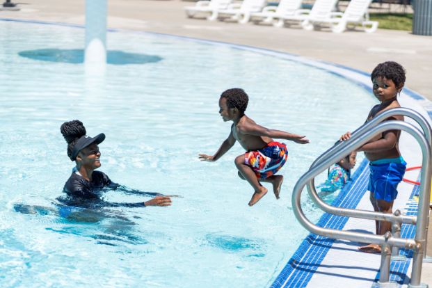 kids jumping into a wading pool