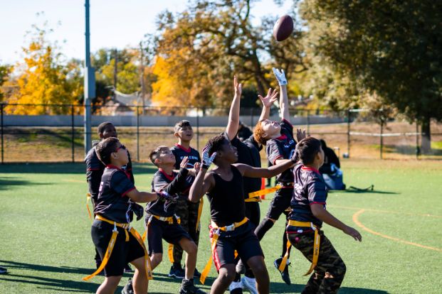 A group of football kids catching a ball