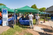 a vendor booth in a park with people at it