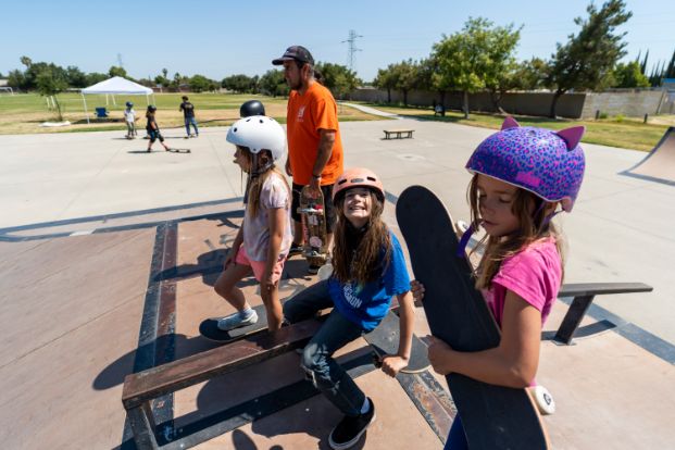 young skateboarders sitting on rramp