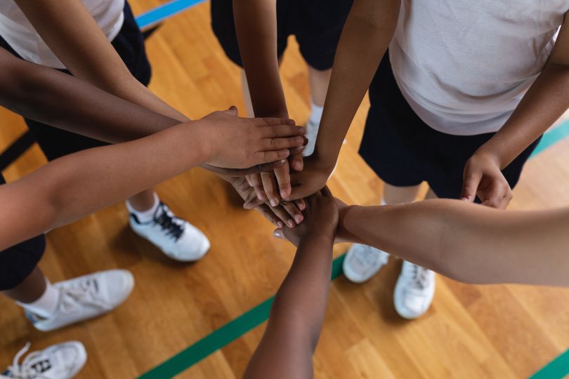 Youth putting their hands together